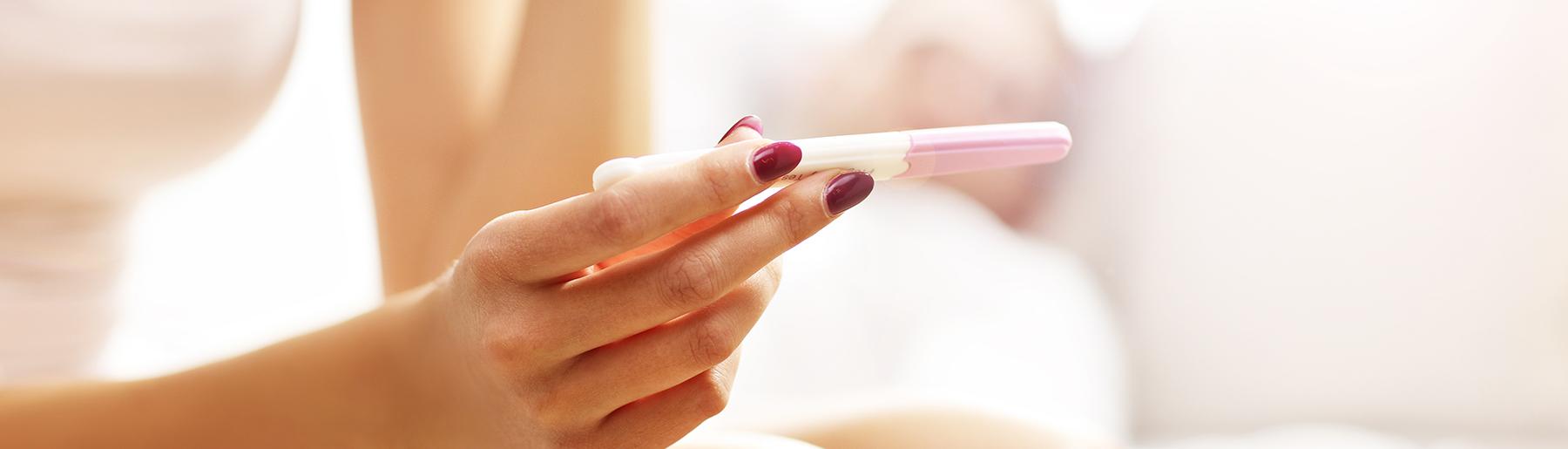 woman hands holding a pregnancy test