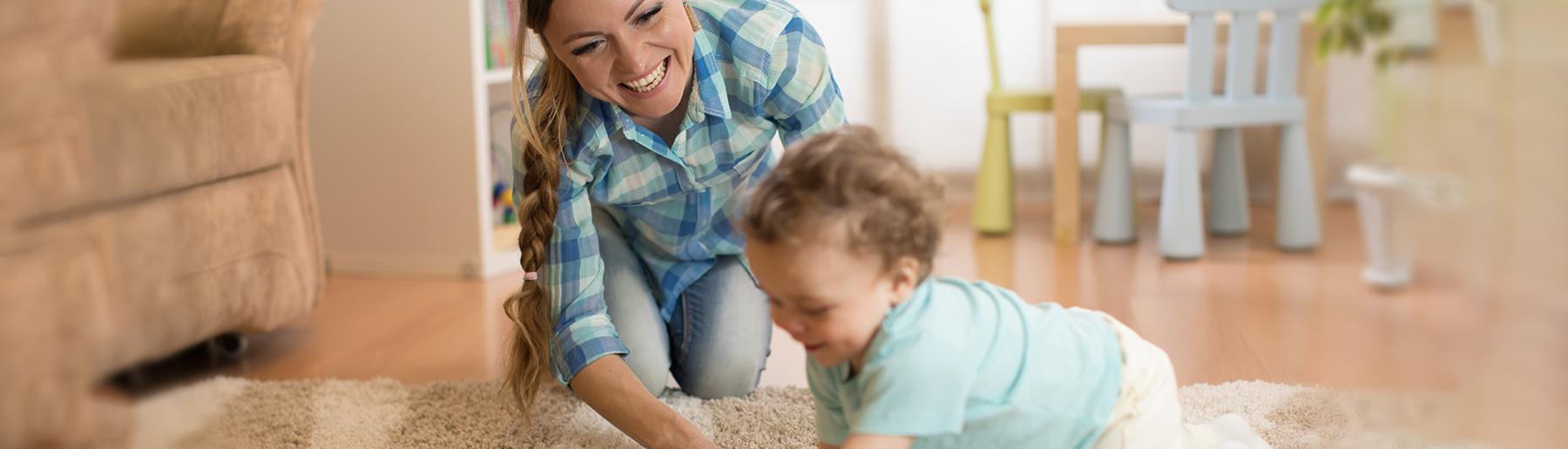 woman playing with baby