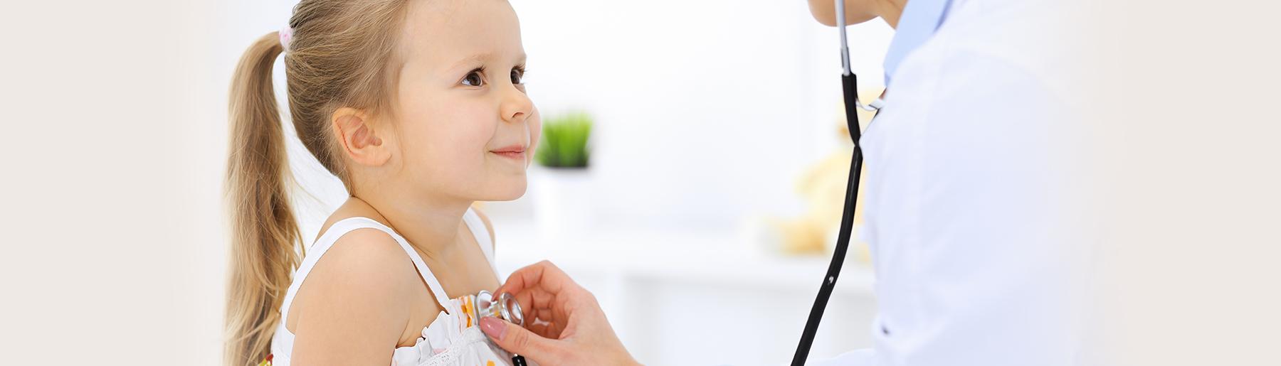 doctor listening to little girl's heart