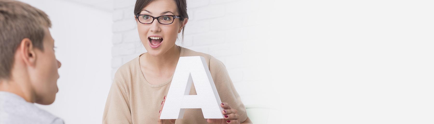 woman holding the letter a